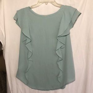 Light green sleeveless top with ruffles.